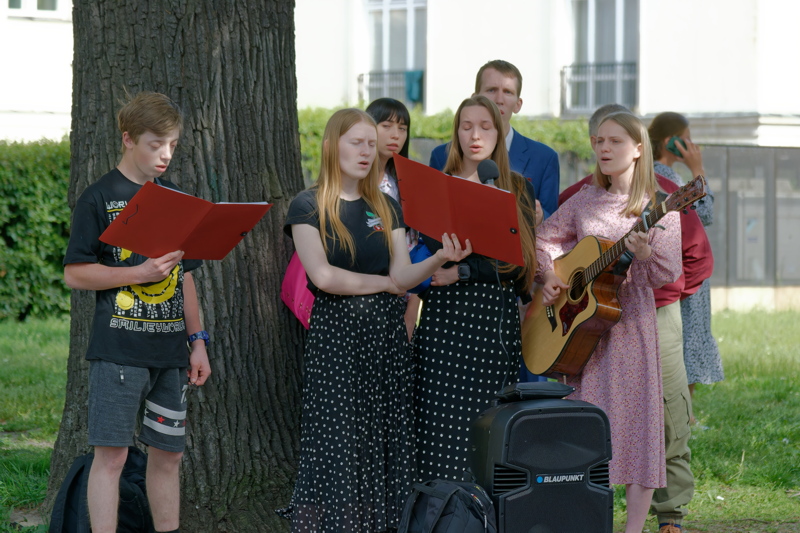 19 - Group of young people gathered outside for a musical performance